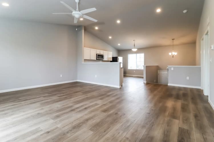 Portage apartments for rent - image - Spacious open-plan living area with modern wood flooring, elegant kitchen, and ample natural light.